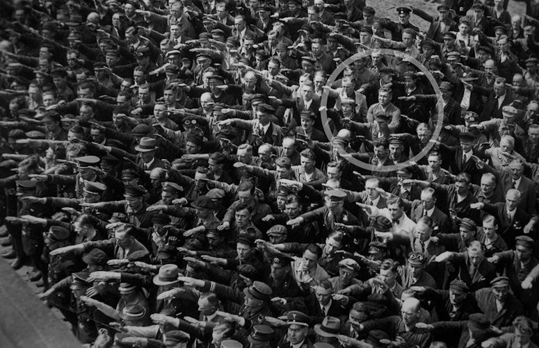 August Landmesser protesterar mot nazisterna. Den enda som inte håller upp handen.